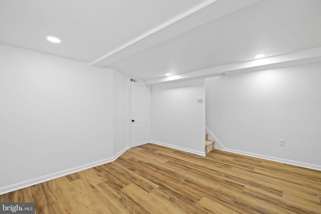 basement featuring hardwood / wood-style floors