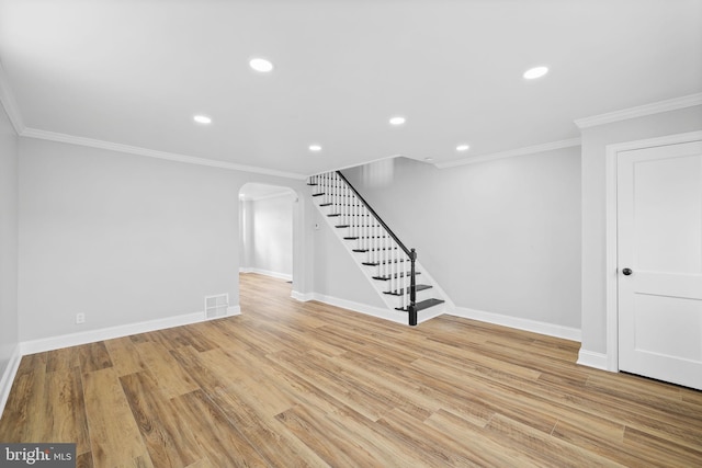 unfurnished living room with light hardwood / wood-style floors and crown molding