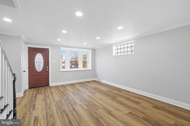 foyer entrance featuring ornamental molding and light wood-type flooring