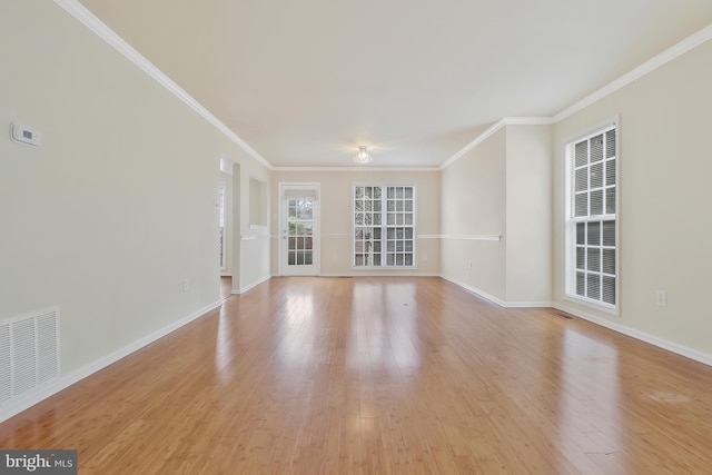 unfurnished living room with light hardwood / wood-style flooring and ornamental molding