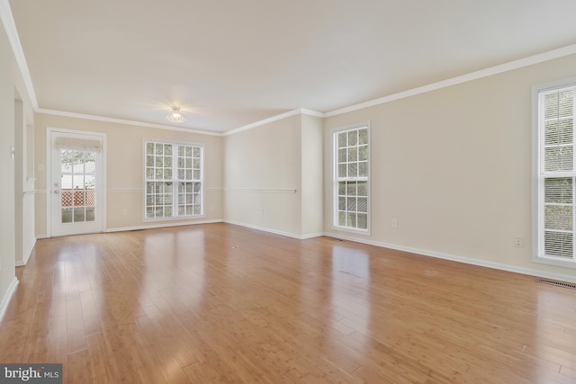 unfurnished room with light wood-type flooring and ornamental molding