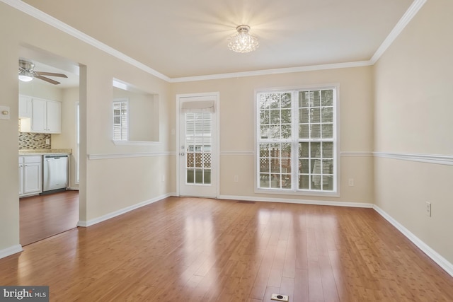 interior space featuring light hardwood / wood-style floors, ceiling fan with notable chandelier, and ornamental molding