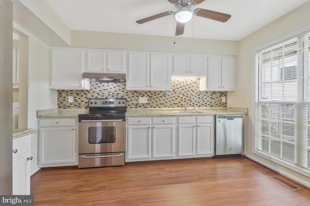 kitchen with white cabinetry, ceiling fan, stainless steel appliances, and light hardwood / wood-style floors