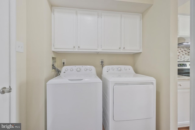 laundry area featuring cabinets and washer and clothes dryer