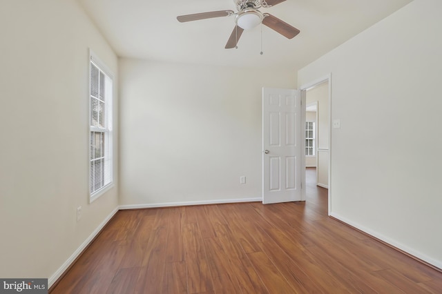 spare room with a wealth of natural light and hardwood / wood-style floors