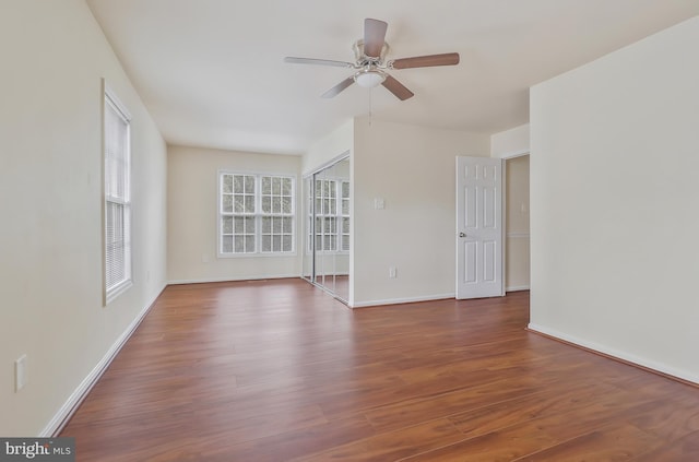 spare room with ceiling fan and dark hardwood / wood-style floors