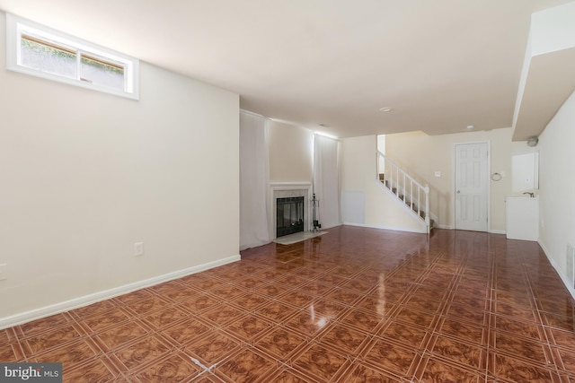 unfurnished living room featuring a fireplace