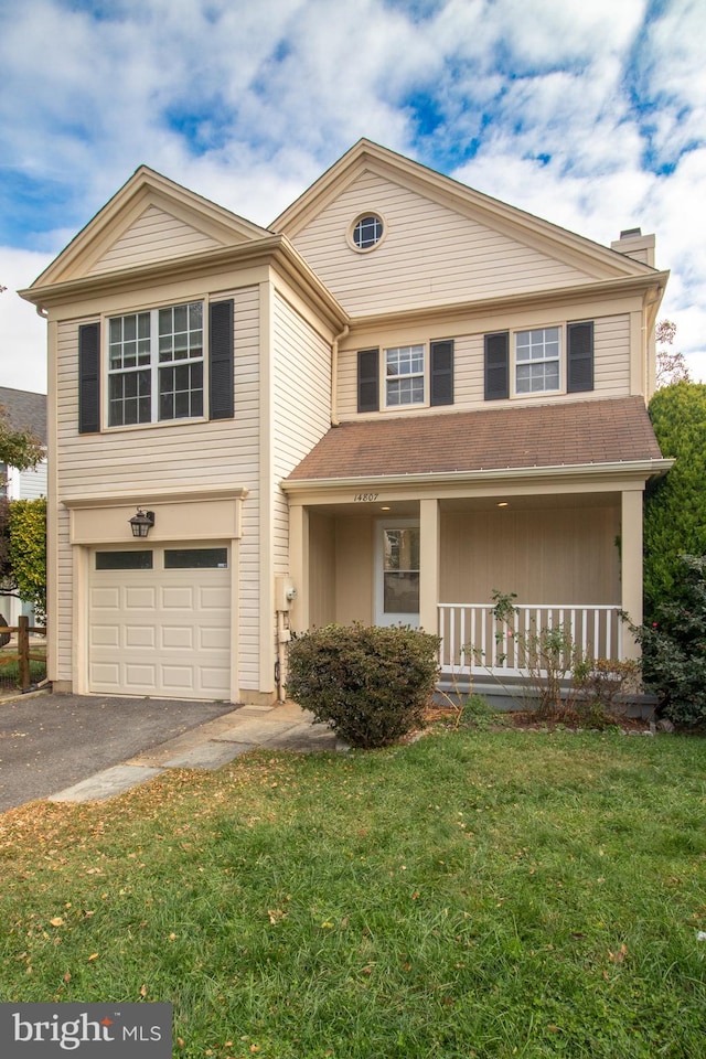 view of front of house featuring a porch, a garage, and a front yard