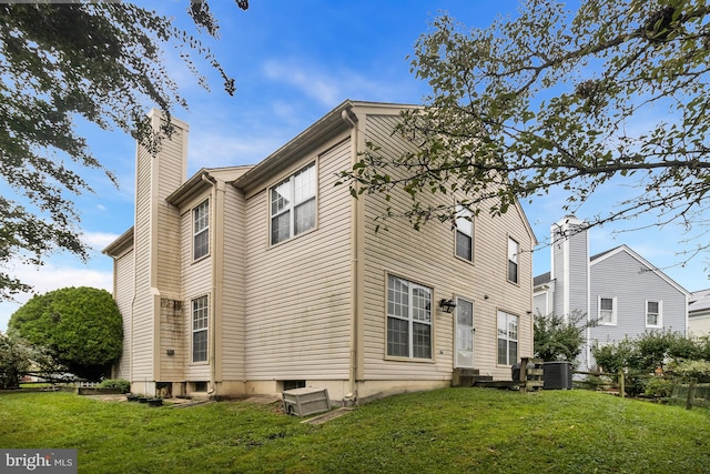 view of property exterior featuring central air condition unit and a lawn