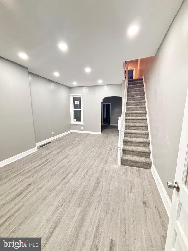 basement with light hardwood / wood-style flooring