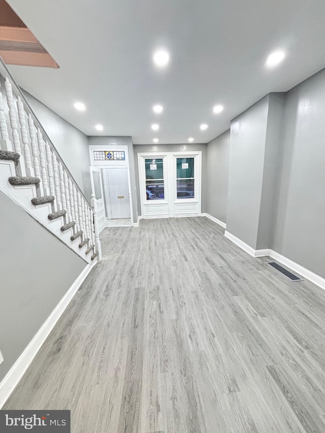 unfurnished living room with light wood-type flooring