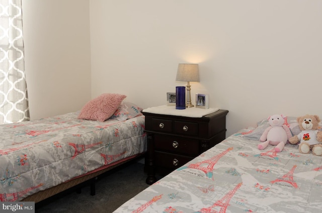 bedroom with dark colored carpet