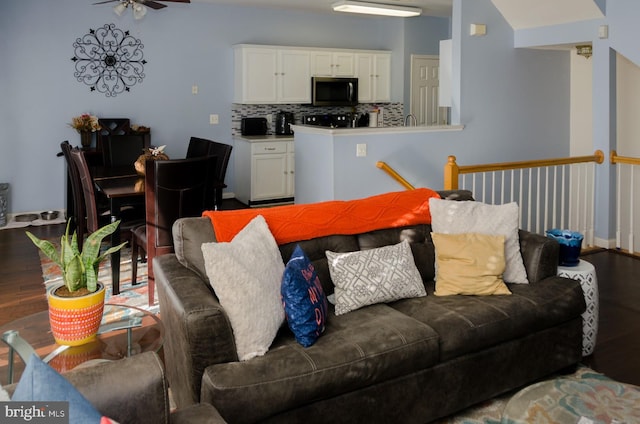 living room with ceiling fan and hardwood / wood-style floors