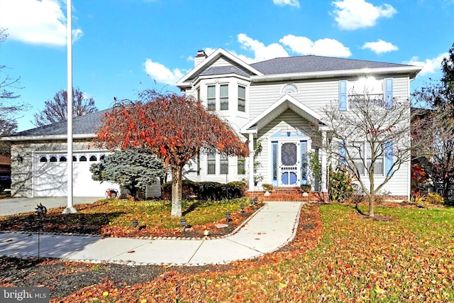 front facade featuring a garage and a front lawn