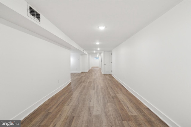 corridor featuring wood-type flooring