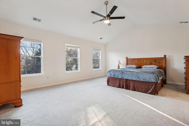 carpeted bedroom with ceiling fan, lofted ceiling, and multiple windows