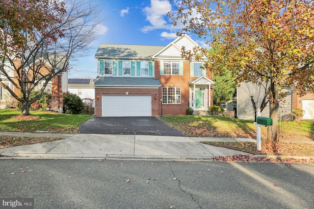 view of front of home featuring a garage and a front lawn