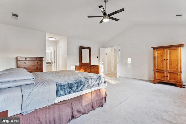 bedroom with ensuite bathroom, vaulted ceiling, ceiling fan, and light colored carpet