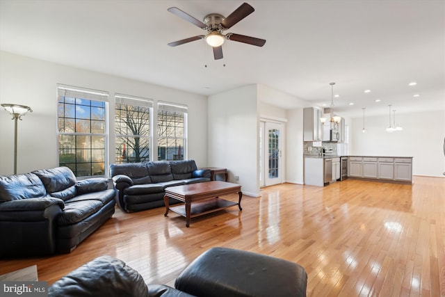 living room with ceiling fan and light wood-type flooring