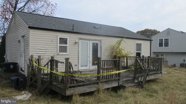 back of house with central AC and a deck