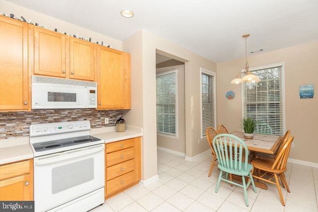 54 October Glory Ave Unit 54F, Ocean View, DE 19970 - kitchen featuring white appliances, a chandelier, tasteful backsplash, and baseboards