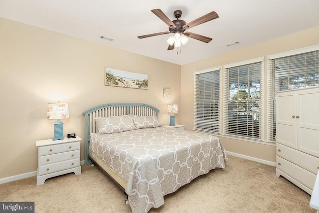 bedroom with ceiling fan and light colored carpet