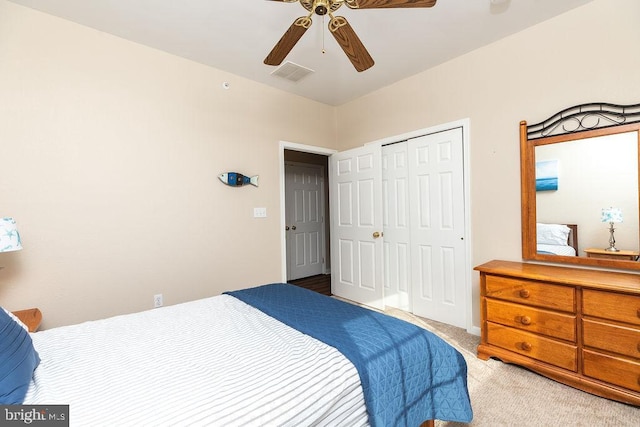 carpeted bedroom with ceiling fan and a closet