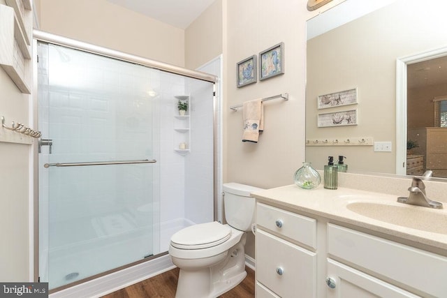 bathroom featuring hardwood / wood-style floors, vanity, an enclosed shower, and toilet