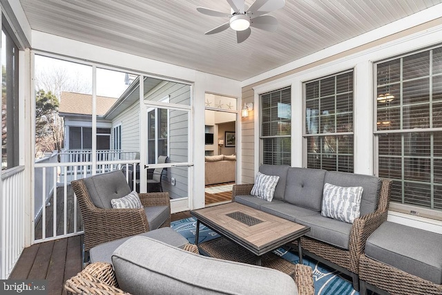 sunroom / solarium featuring ceiling fan