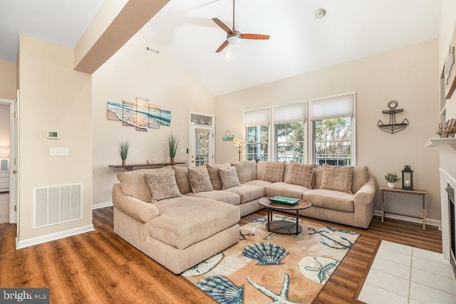 living room featuring ceiling fan, high vaulted ceiling, and wood-type flooring