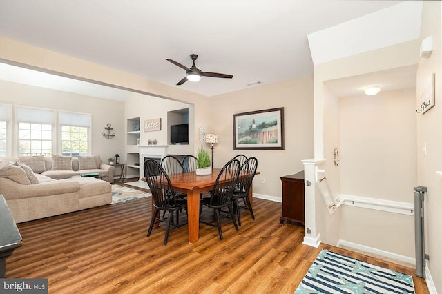 dining room with ceiling fan and hardwood / wood-style flooring