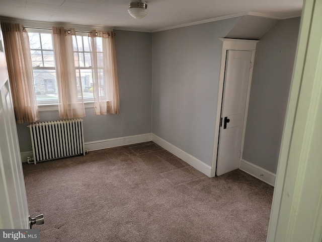 unfurnished room with carpet and radiator