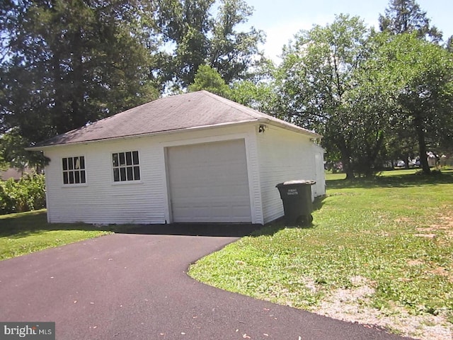 garage featuring a yard