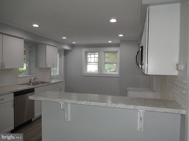 kitchen featuring dark hardwood / wood-style flooring, stainless steel appliances, white cabinetry, and a wealth of natural light