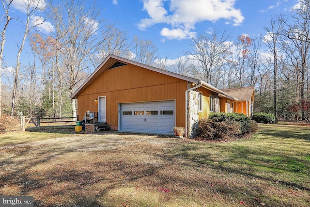 view of property exterior featuring a lawn and a garage