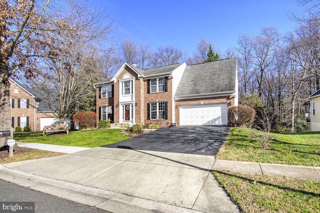 view of front of house featuring a garage and a front lawn