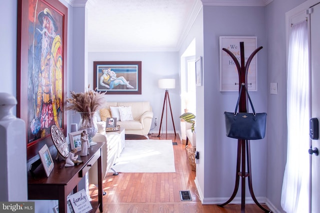 interior space with crown molding and light hardwood / wood-style flooring