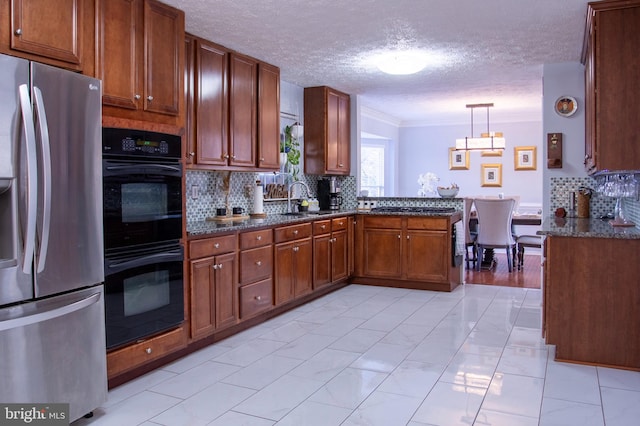 kitchen featuring hanging light fixtures, stainless steel refrigerator with ice dispenser, double oven, kitchen peninsula, and ornamental molding