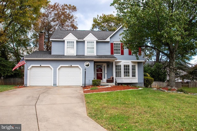 view of front property featuring a front lawn and a garage