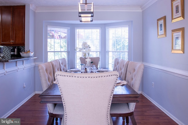 dining space with dark wood-type flooring and ornamental molding