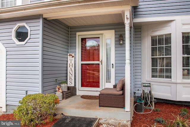 view of exterior entry with a porch