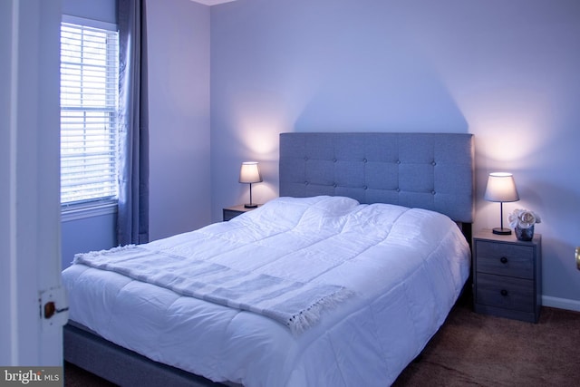 bedroom with dark colored carpet