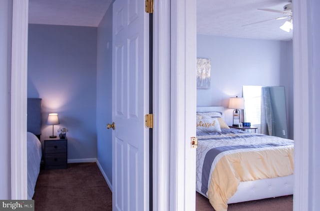 bedroom featuring dark carpet and ceiling fan