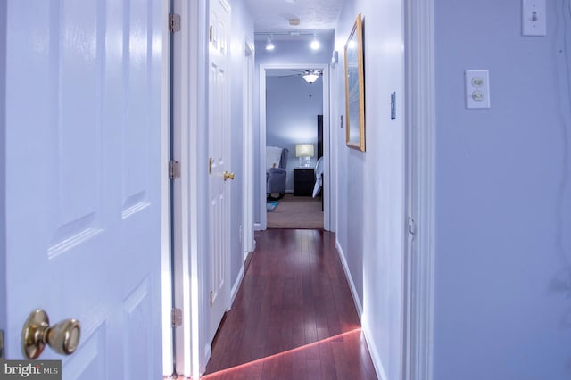 hall featuring dark hardwood / wood-style flooring and a textured ceiling