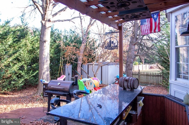 view of patio / terrace with a storage shed and a wooden deck