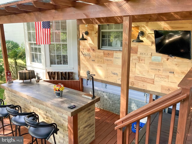 wooden deck featuring exterior bar