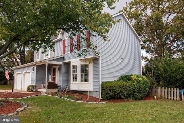 view of front property featuring a garage and a front lawn