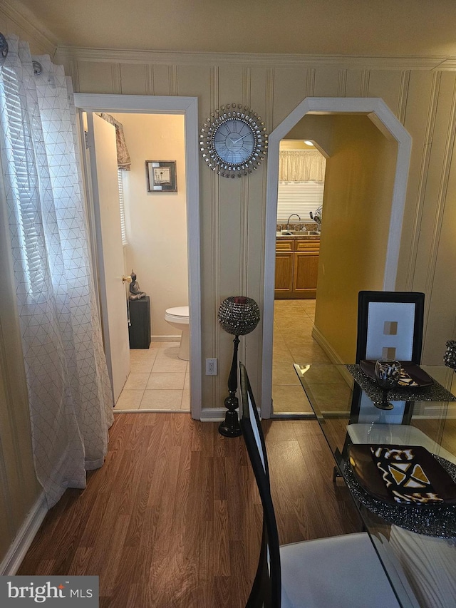 hallway featuring sink and light hardwood / wood-style flooring