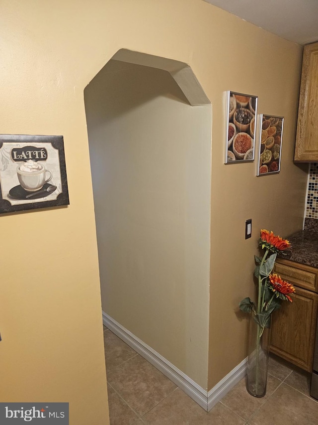 hallway featuring light tile patterned floors