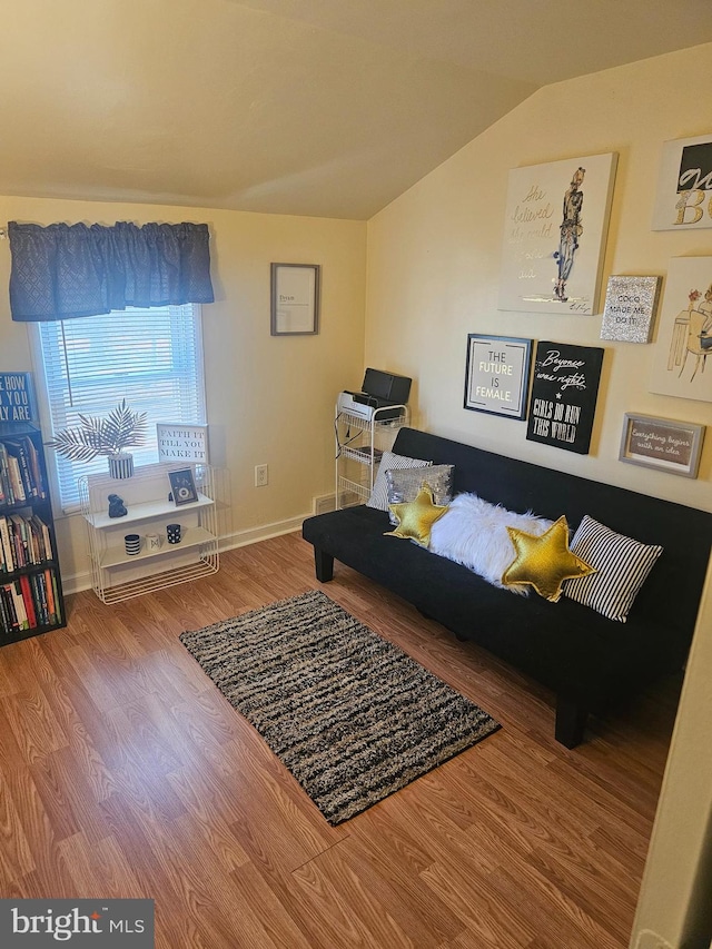 living room featuring hardwood / wood-style flooring and lofted ceiling